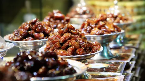 	several bowls of dates on a table