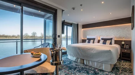 Interior of bedroom with floor to ceiling window view aboard the George Eliot ship