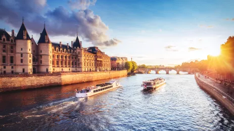 An image of two ships crossing the Seine River, during the day