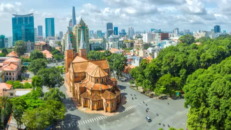 Notre Dame Cathedral with high-rise buildings in the background in Ho Chi Minh City, Vietnam.