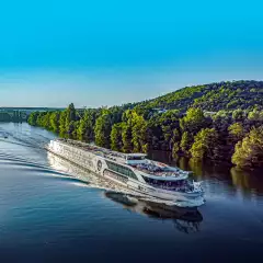 Image of the jane austen sailing down the calm waters of the river rhine against a blue sky