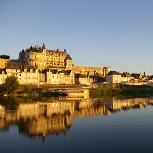 Amboise castle reflected in the water at dusk, France