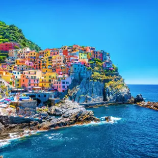 Colourful buildings along the cliffside of Cinque Terre over the Mediterranean sea