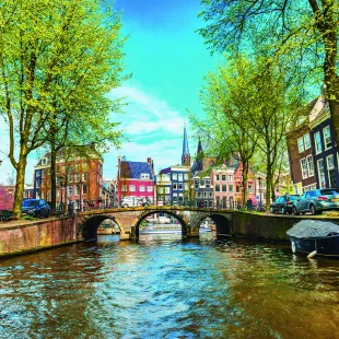 Water canal with traditional houses in Amsterdam