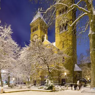 St. Michael church covered in snow at night in Cologne, Germany