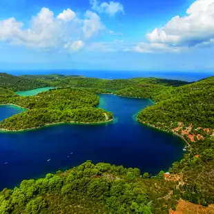 Aerial shot of the National Park on the island of Mijet, Croatia. Also known as a “green island” for its lush vegetation, its beauty consists of contrasting rocks, caves and cliffs against blue waters.