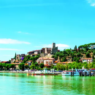 Brightly coloured Lake Trasimeno with anchored boats in the province of Perugia, Umbria, Italy.