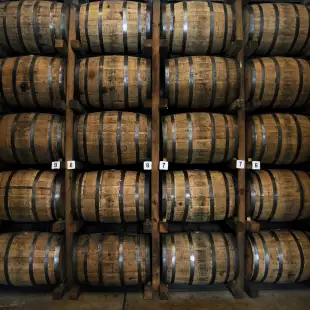 Stacked wooden whiskey barrels