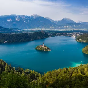 Wide shot of Lake Bled with greenery and mountains in Slovenia, Europe