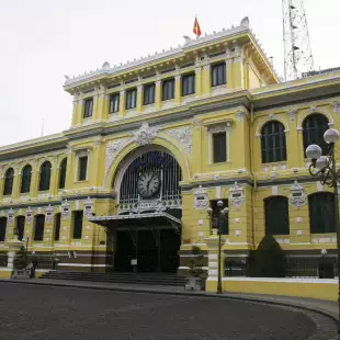 Saigon Central Post Office, large yellow building with white accents, Vietnam.