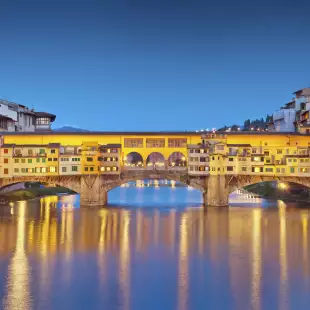 Panorama of Ponte Vecchio bridge and houses at twilight in Florence, Italy