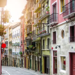 Rows of buildings in narrow ancient street in Pamplona city, Spain