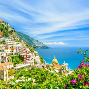 Positano on Amalfi coast with blurred flowers on foreground in Campania, Italy