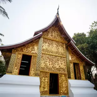 Wat Xiengthong Buddhist temple with gold exterior in Laos