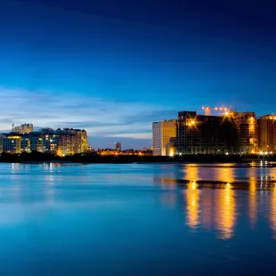 Night time shot of buildings on the edge of the water in Chennai