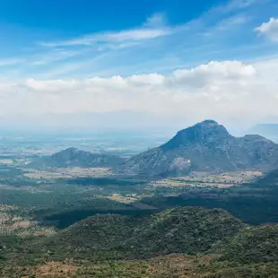 View of Western Ghats mountains under a blue sky and clouds, India