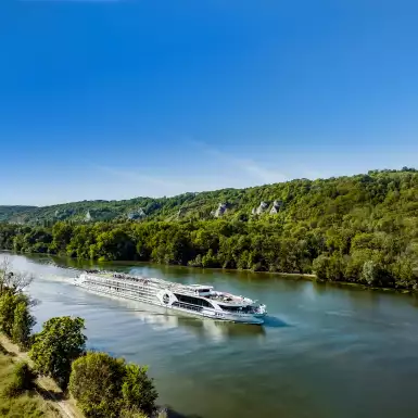 The Jane Austin luxury cruise boat from Riviera sailing down the Douro with blue skies