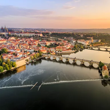 Aerial view of Prague Castle, cathedral and Charles Bridge at sunrise in Prague