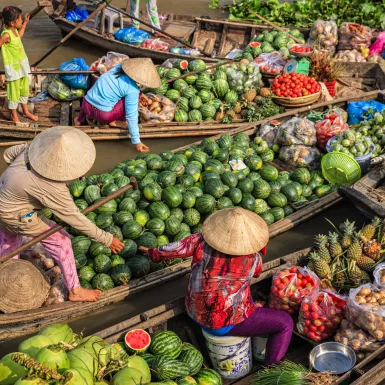 Women selling fruits on floating market on Mekong River in Delta,Vietnam