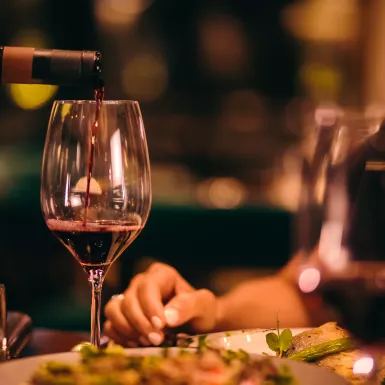 Close-up of red wine being served at fine dining restaurant