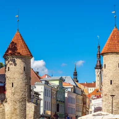 Two round guard towers of Viru Gate against bright blue sky in Tallinn, Estonia. 