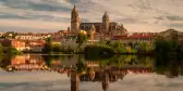 Salamanca Cathedral reflected on Tormes River during sunset in Salamanca, Spain