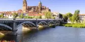 View of bridge across river in Spain with Salamanca cathedral in the background