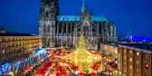 Christmas market and Catholic cathedral at night in the city of Cologne, Germany