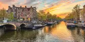 Sunset city skyline at canal waterfront in Amsterdam, Netherlands