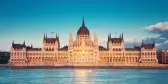 Parliament building with sun setting in windows in Budapest, Hungary