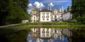 Mateus Palace by a decorative pond, it's reflection mirrored in the water, Portugal