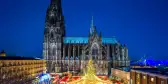 Christmas market and Catholic cathedral at night in the city of Cologne, Germany