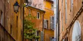 Narrow street between buildings in Aix Old town, France