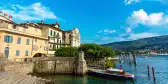 Landscape of Lake Maggiore, Stresa, Italy. With a staircase leading into the river and a small boat.