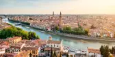 A central shot of the Adige river surrounded by european roofs of Verona