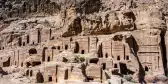 Desert canyon walls lined with carved stone tombs entrances, Jordan