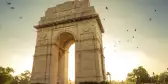 Sunrise over the India Gate, stone monument archway in New Delhi, India