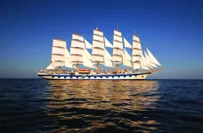 Exterior shot of the Royal Clipper ship at sea against a dark blue sky