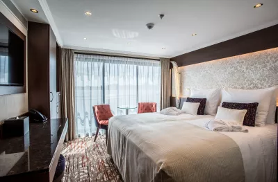 Interior shot of bedroom aboard the Oscar Wilde cruise ship