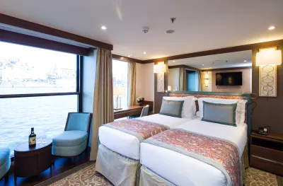 Superior suite with twin beds and balcony aboard the MS Douro Elegance ship