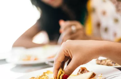 Indian Woman Eating with hands at restaurant in India