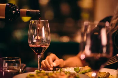 Close-up of red wine being served at fine dining restaurant