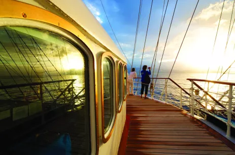 Woman taking picture of sunset aboard the Royal Clipper ship