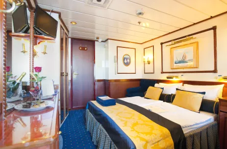 Classical style double bed cabin aboard the Star Flyer with blue and yellow decor