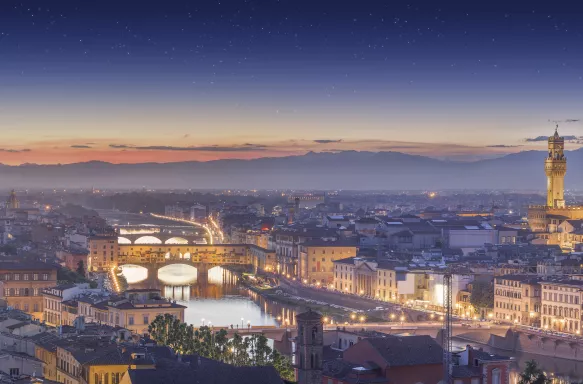 Panorama of Arno River and Ponte Vecchio at sunset in Florence, Italy