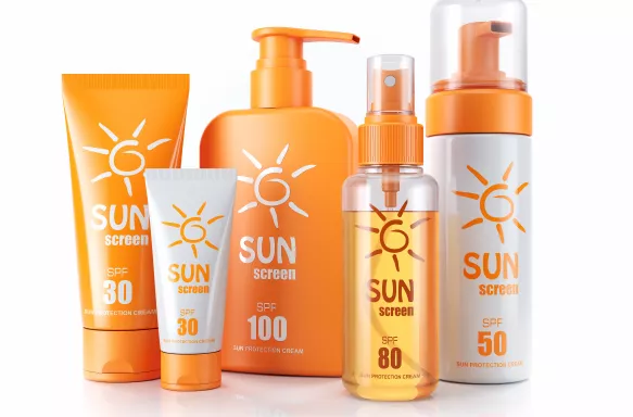 Set of sunscreens. Cream, oil and spray against a plain white background.