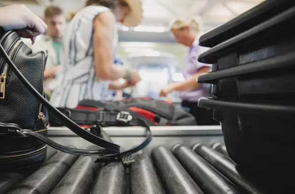 Close-up shot of luggage being inspected by security at the airport