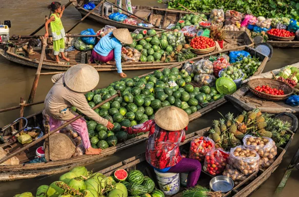 Women selling fruits on floating market on Mekong River in Delta,Vietnam