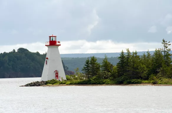 Distant view of Kidston lighthouse on Bras D'Or lake in Canada