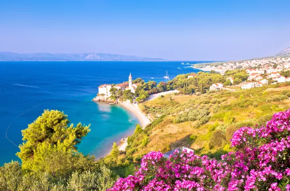 Monastery on pebble beach and sea on the island of Brac in Croatia